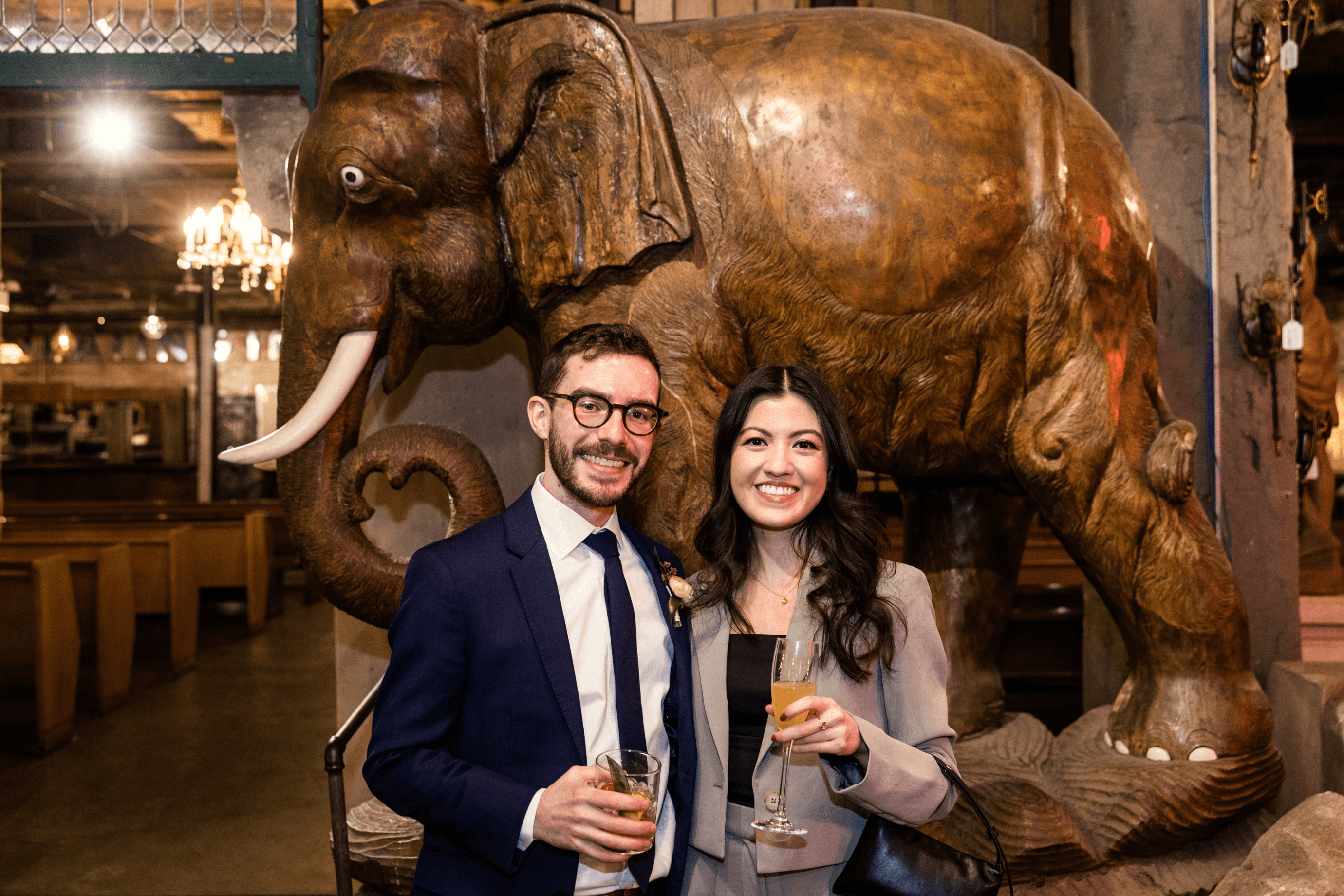 Delanie and Jonathan in front of a giant wooden elephant